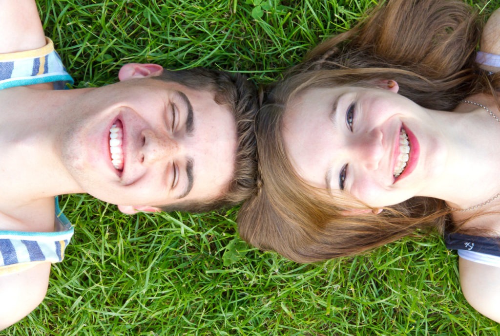 couple smiling in grass