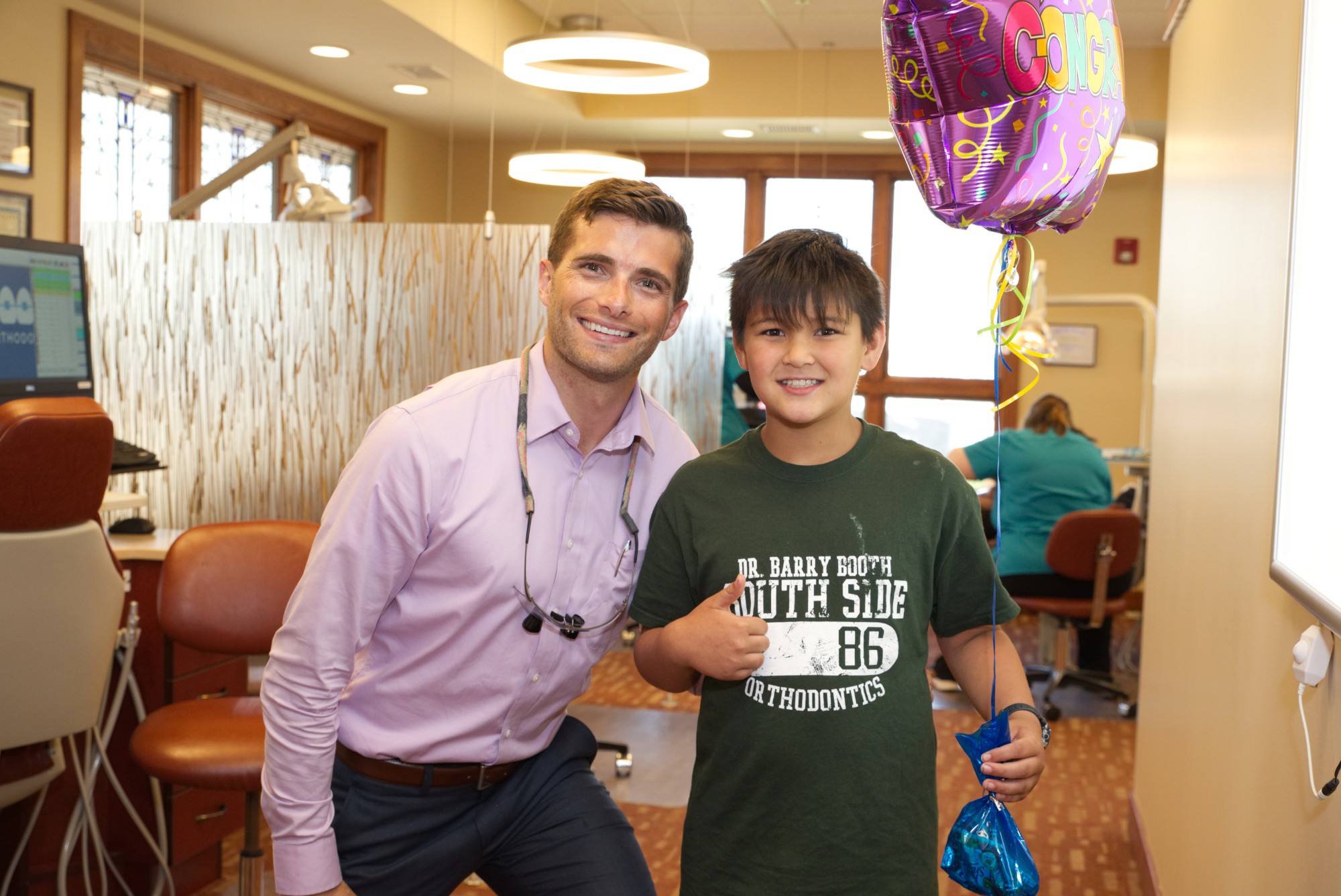 dr ryan booth and young male patient with a balloon