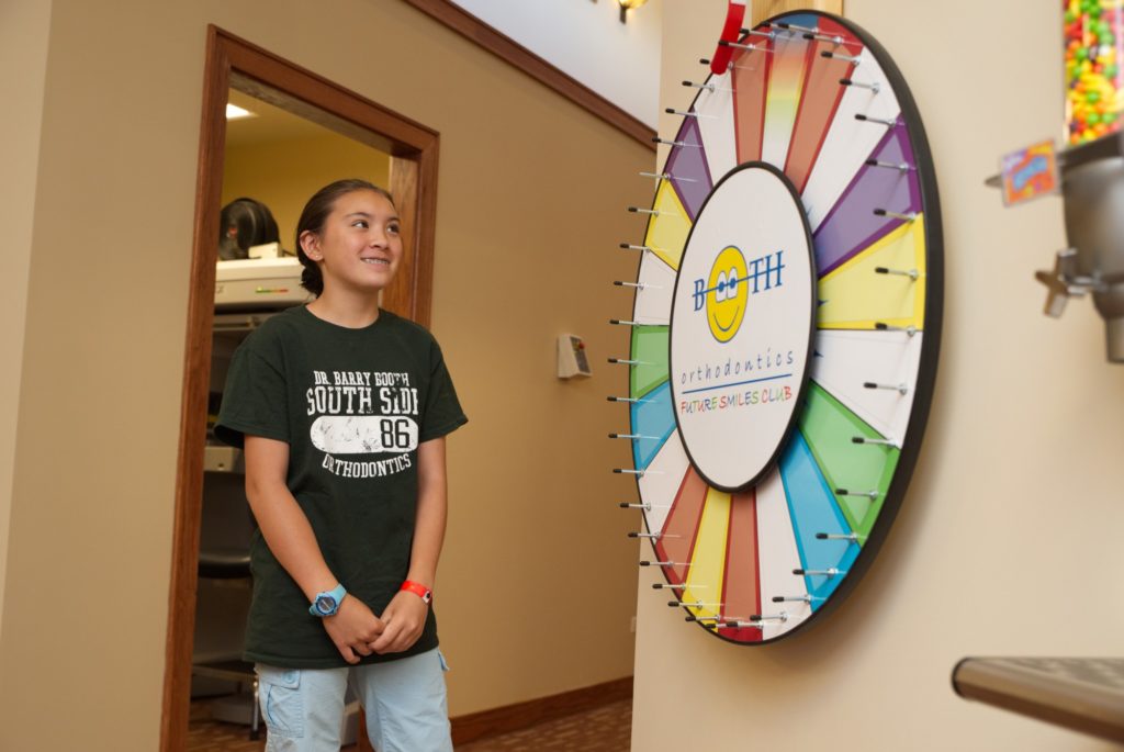 teen girl spinning prize wheel