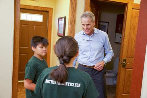 Dr. Booth with braces patients